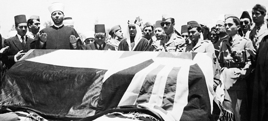 (Original Caption) 7/29/1951-Amman, Jordan- Members of the royal family are shown standing behind the flag-draped coffin of assassinated King Abdullah of Jordan, as prayers are offered before burial, in the royal cemetery at Amman. From left to right are: behind coffin, Prince Abdullah, Iraq regent; Prince Naif, 35-year-old brother of Prince Talal, who was chosen by the cabinet to secede the late King and whose appointment made Prince Talal furious; Prince Houssein, son of Prince Talal and Prince Fahed of Saudi Arabia.
