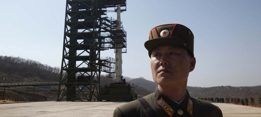 A soldier stands guard in front of the Unha-3 (Milky Way 3) rocket sitting on a launch pad at the West Sea Satellite Launch Site, during a guided media tour by North Korean authorities in the northwest of Pyongyang April 8, 2012. North Korea has readied a rocket for a launch from a forested valley in its remote northwest this week that will showcase the reclusive state's ability to fire a missile with the capacity to hit the continental United States. Picture taken April 8, 2012. REUTERS/Bobby Yip (NORTH KOREA — Tags: POLITICS MILITARY) ORG XMIT: PYG17