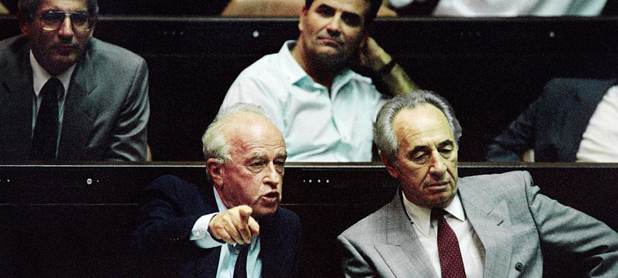 Israeli Prime Minister Yitzhak Rabin (L), sitting next to his Foreign Minister Shimon Peres (R), points at the Likud during an argument during the presentation of his government at the opening session of the Knesset on July 13, 1992. AFP PHOTO PATRICK BAZ / AFP / PATRICK BAZ (Photo credit should read PATRICK BAZ/AFP/Getty Images)