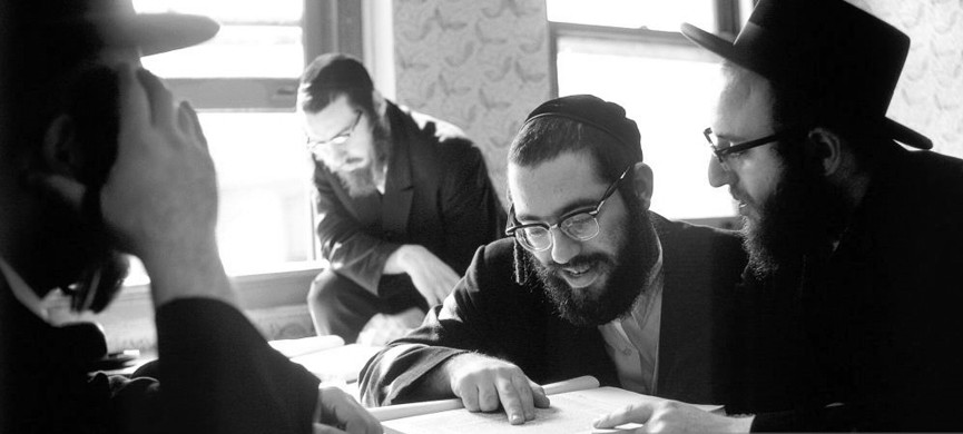 BROOKLYN, NY � OCTOBER 25, 1972: Hasidic Jewish men studying books of Talmud and Jewish law in yeshiva in Williamsburg, Brooklyn, New York on October 25, 1972. The students are wearing beards, yarmulkes, glasses, and hair sidelocks (side locks) (peyes). The men are being trained to be rabbis at the Satmer Yeshiva school of rabbinical studies. The students are mostly from the religious and observant Satmer Hasidim community in Williamsburg, Brooklyn. The classes are held in English and Yiddish language, and the books are in Hebrew. (Photo by Nathan Benn/Corbis via Getty Images)