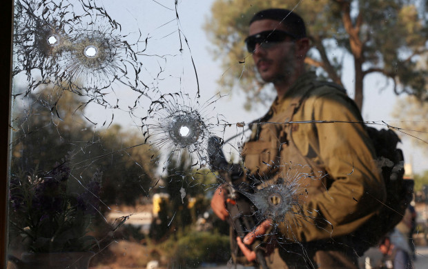 <p>An Israeli soldier walks next to bullet holes, in the aftermath of a mass infiltration by Hamas gunmen from the Gaza Strip, in Kibbutz Beeri in southern Israel, October 14, 2023. REUTERS/Violeta Santos Moura TPX IMAGES OF THE DAY</p>