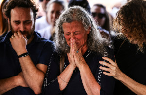 <p>Friends and family mourn at the funeral of Eytam Magini who was killed during a Tel Aviv bar attack by a Palestinian gunman, in Kfar Saba, Israel, April 10, 2022. REUTERS/Ronen Zvulun</p>