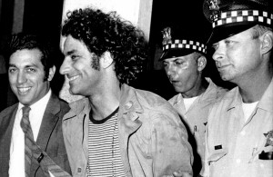 <p>Abbie Hoffman, leader of the Youth International Party known as the Yippies, is escorted by police after his arrest at O'Hare Field in Chicago upon his arrival from New York on Sept. 17, 1968. He was sought for not appearing in court on Sept. 6 to answer charges of disorderly conduct and resisting arrest. Police said a switchblade knife and a knife with a four-inch blade was found on Hoffman, who was then booked on charges of unlawful use of weapon. At left is his attorney Gerald B. Lafcourt. (AP Photo)</p>