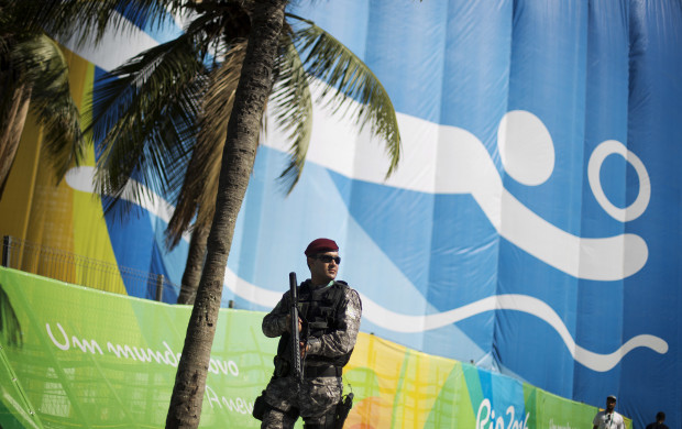 <p>A National Security Force officer patrols outside the beach volleyball arena along Copacabana Beach ahead of the upcoming 2016 Summer Olympics in Rio de Janeiro, Brazil, Tuesday, Aug. 2, 2016. (AP Photo/David Goldman)</p>