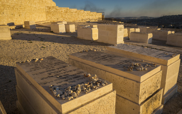 <p>Horizontal close-up view of some of the graves of the Mount of Olives Jewish Cemetery, with the smoke on Gaza Strip in the background, in Jerusalem</p>