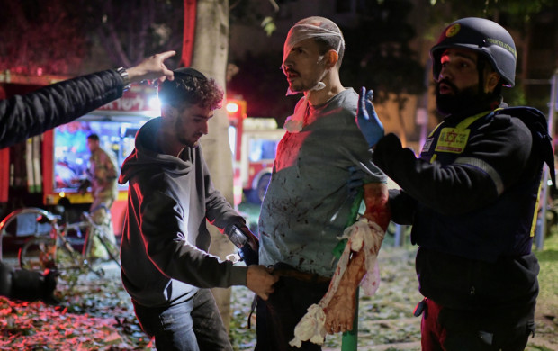 <p>Rescue workers bandage a wounded man and provide first aid at the site of a direct hit from an Iranian missile strike in Tel Aviv, Israel, Saturday, Feb. 28, 2026. (AP Photo/Tomer Neuberg)</p>
