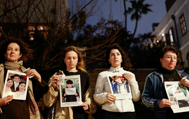 <p>Activists stand with pictures of children killed in Israel, Palestine, Iran and Lebanon, in a silent vigil calling for an end to the ongoing U.S.-Israeli conflict with Iran, in Tel Aviv, Israel, March 19, 2026. REUTERS/Amir Cohen</p>