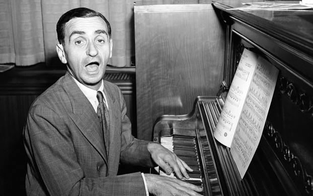 <p>"Be Careful, It's My Heart," is the song Irving Berlin sings during an interview in Berlin's New York office, July 16, 1942. Besides appearing in the army relief show, "This Is The Army" which he wrote and produced, the noted composer has written several new songs for a movie. (AP Photo/Murray Becker)</p>