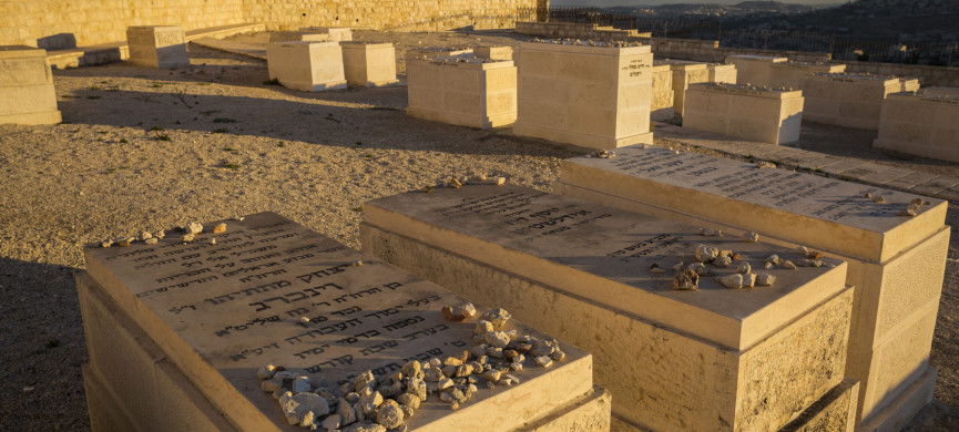 <p>Horizontal close-up view of some of the graves of the Mount of Olives Jewish Cemetery, with the smoke on Gaza Strip in the background, in Jerusalem</p>