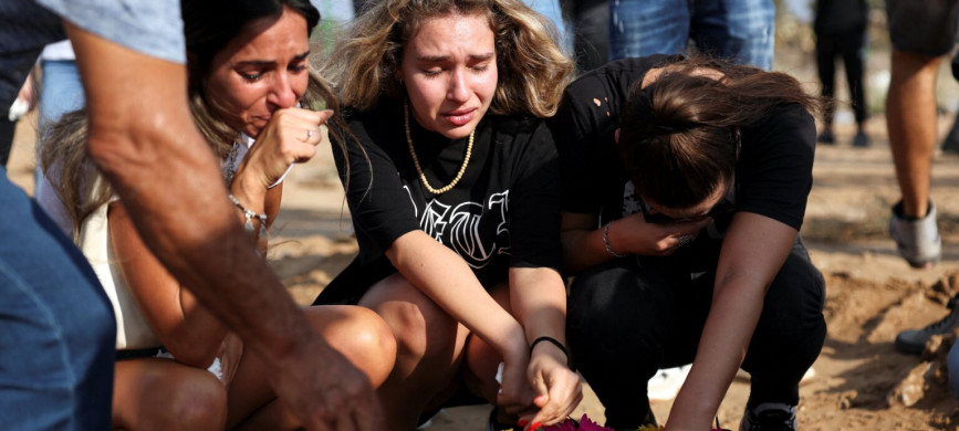 <p>People mourn at the graveside of Eden Guez during her funeral in Ashkelon, Israel, Oct. 10, 2023. She was killed during an Oct. 7 music festival that was attacked by Hamas gunmen from Gaza. Israel increased airstrikes on the Gaza Strip and sealed it off from food, fuel and other supplies Oct. 9 in retaliation for a bloody incursion by Hamas militants. (OSV News photo/Violeta Santos Moura, Reuters)</p>