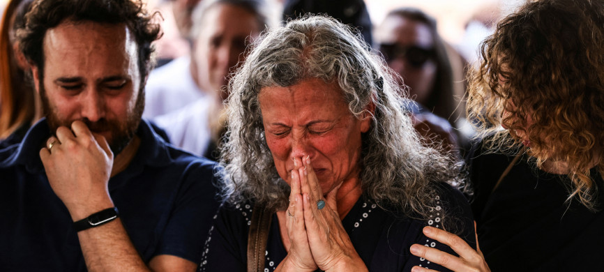 <p>Friends and family mourn at the funeral of Eytam Magini who was killed during a Tel Aviv bar attack by a Palestinian gunman, in Kfar Saba, Israel, April 10, 2022. REUTERS/Ronen Zvulun</p>