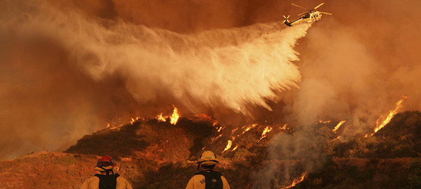 <p>Firefighters watch as water is dropped on the Palisades Fire in Mandeville Canyon Saturday, Jan. 11, 2025, in Los Angeles. (AP Photo/Jae C. Hong)</p>