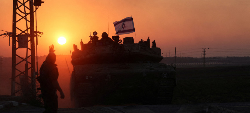 <p>An Israeli soldier looks out from a tank at sunset as an artillery unit gathers near Israel's border with the Gaza Strip, in southern Israel, October 12, 2023. REUTERS/Ronen Zvulun TPX IMAGES OF THE DAY</p>